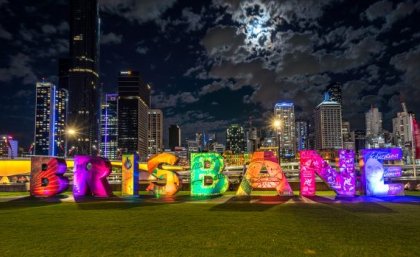 Large block letters placed on a grass patch, reading the name "Brisbane."